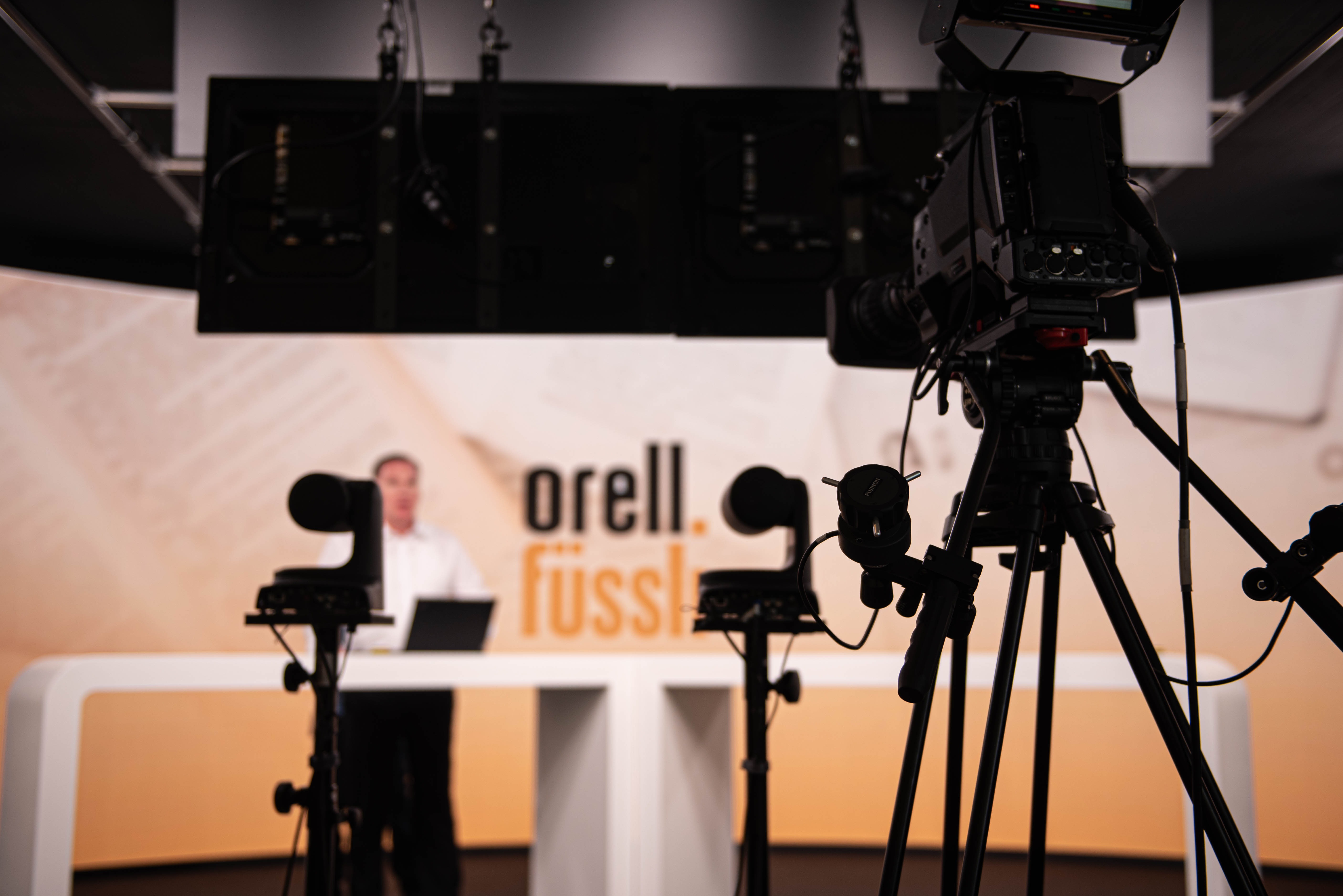 Eine Livestream-Kamera steht parat vor einer Bühne für einen Orell Füssli Livestream.